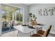 Bright dining area featuring a modern table, stylish chairs, and access to a screened patio at 1612 Eastbrook Blvd, Winter Park, FL 32792