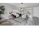 Cozy living room with modern decor, plush seating, stylish rug, and view into the dining area at 1612 Eastbrook Blvd, Winter Park, FL 32792