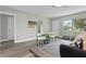 Inviting living room with modern decor, ample natural light, wood-look floors, and a cozy atmosphere at 1612 Eastbrook Blvd, Winter Park, FL 32792