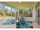 Relaxing screened porch featuring outdoor seating and a view of the lush backyard at 1612 Eastbrook Blvd, Winter Park, FL 32792