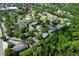 An aerial view of the community featuring a pond, tennis courts, mature trees and plenty of parking at 164 Reserve Cir # 208, Oviedo, FL 32765