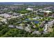 Scenic aerial view of a neighborhood with ponds, a pool, clubhouse, and lush landscaping with a red pin at 164 Reserve Cir # 208, Oviedo, FL 32765