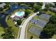 Aerial view of a community with a pool, tennis courts, basketball court, and scenic pond at 164 Reserve Cir # 208, Oviedo, FL 32765