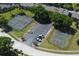 Aerial view of tennis court and basketball court, alongside parking area in residential community at 164 Reserve Cir # 208, Oviedo, FL 32765
