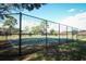 View of the community basketball court with a fence, hoop and well maintained court at 164 Reserve Cir # 208, Oviedo, FL 32765