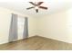Bedroom with wood-look flooring, a ceiling fan, and a window at 164 Reserve Cir # 208, Oviedo, FL 32765
