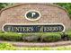 Hunter's Reserve community sign with brick surround and greenery at 164 Reserve Cir # 208, Oviedo, FL 32765