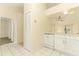 Well-lit kitchen features white cabinets, tile flooring, and modern appliances at 164 Reserve Cir # 208, Oviedo, FL 32765
