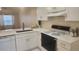 Bright kitchen features white cabinets, quartz countertops, stainless faucet, and modern appliances at 164 Reserve Cir # 208, Oviedo, FL 32765