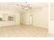 Bright and airy living space with open view to kitchen, tile floors, and ceiling fan at 164 Reserve Cir # 208, Oviedo, FL 32765