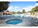 Community pool with hot tub, sun loungers, and shaded pergola in a tropical setting at 164 Reserve Cir # 208, Oviedo, FL 32765