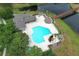 Stunning aerial view of a community pool with a wooden bridge across a scenic pond at 164 Reserve Cir # 208, Oviedo, FL 32765