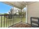 Screened-in porch view of a grassy common area and mature trees at 164 Reserve Cir # 208, Oviedo, FL 32765