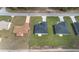 Aerial view of a neighborhood with well-maintained lawns and modern homes with sleek, dark roofs at 17046 Sw 44Th Cir, Ocala, FL 34473