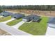 Aerial view of three modern homes with well-manicured lawns and pristine driveways in a neighborhood at 17046 Sw 44Th Cir, Ocala, FL 34473