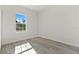 Well-lit bedroom featuring wood-look flooring, a large window, and freshly painted walls at 17046 Sw 44Th Cir, Ocala, FL 34473