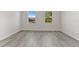 This bedroom features wood-look flooring and bright natural lighting at 17046 Sw 44Th Cir, Ocala, FL 34473