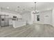 Modern kitchen features stainless appliances, shaker cabinets, large island, and stylish pendant lighting at 17046 Sw 44Th Cir, Ocala, FL 34473