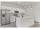 Modern kitchen with white cabinetry, stainless steel appliances, and a kitchen island at 17046 Sw 44Th Cir, Ocala, FL 34473