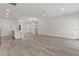 Open-concept living space with hardwood floors and recessed lights, and a modern kitchen at 17046 Sw 44Th Cir, Ocala, FL 34473