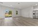 Spacious living room features a sliding glass door, hardwood floors and stainless fridge at 17046 Sw 44Th Cir, Ocala, FL 34473