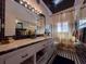 Classic bathroom with a vanity, ornate light fixtures, and shower with curtain at 202 S Hampton Ave, Orlando, FL 32803