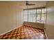 Bedroom featuring a ceiling fan, large window, and unique checkered wood flooring design at 202 S Hampton Ave, Orlando, FL 32803