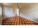 Bedroom featuring checkered flooring, closet space, neutral paint and open doorway with a ceiling fan at 202 S Hampton Ave, Orlando, FL 32803