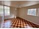 Bright bedroom with checkered floors, neutral walls, a ceiling fan and large windows for ample natural light at 202 S Hampton Ave, Orlando, FL 32803