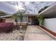 Charming single-story home featuring desert landscaping and a welcoming walkway to the front entrance at 202 S Hampton Ave, Orlando, FL 32803
