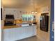 Well-lit kitchen with white cabinetry, an island with butcher block countertops, and stainless steel appliances at 202 S Hampton Ave, Orlando, FL 32803