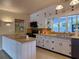 Bright kitchen with white cabinets, butcher block countertops, and modern appliances at 202 S Hampton Ave, Orlando, FL 32803