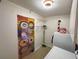 Functional laundry room featuring washer, dryer, storage cabinets and shelving for organization at 202 S Hampton Ave, Orlando, FL 32803