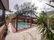 Backyard pool with a screened enclosure featuring lush landscaping and a private outdoor retreat at 202 S Hampton Ave, Orlando, FL 32803