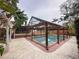 Backyard pool with a screened enclosure featuring lush landscaping and a private outdoor retreat at 202 S Hampton Ave, Orlando, FL 32803
