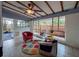 Bright sun room features a ceiling fan, colorful rug, and backyard views at 202 S Hampton Ave, Orlando, FL 32803