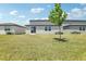 Expansive backyard with neutral-toned homes, sliding glass doors and well-maintained green grass at 2094 Rosewood Dr, Bartow, FL 33830