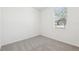 Sunlit bedroom with a window and neutral carpet at 2094 Rosewood Dr, Bartow, FL 33830