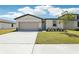Charming single-story home featuring a well-manicured lawn and a two car garage at 2094 Rosewood Dr, Bartow, FL 33830