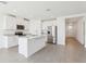 Bright kitchen boasts an island, stainless steel appliances, and white cabinets at 2094 Rosewood Dr, Bartow, FL 33830