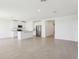 Open concept kitchen featuring white cabinets, stainless steel appliances, and a center island with bar seating at 2094 Rosewood Dr, Bartow, FL 33830