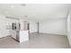 Spacious living area with an open floor plan, flowing into the kitchen, and light hardwood flooring at 2094 Rosewood Dr, Bartow, FL 33830