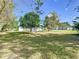 Expansive backyard featuring lush lawn space and mature trees creating a serene and private outdoor environment at 2411 Crawford Dr, Sanford, FL 32771