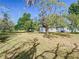 Expansive backyard with mature trees creating a tranquil and shaded outdoor space at 2411 Crawford Dr, Sanford, FL 32771