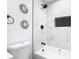 Clean bathroom with a black shower head, bathtub, and white marble tile at 2411 Crawford Dr, Sanford, FL 32771