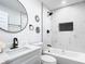 Modern bathroom featuring sleek black fixtures, stylish geometric tile accents, and a marble countertop at 2411 Crawford Dr, Sanford, FL 32771