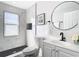 Elegant bathroom showcasing marble tile, black hardware, and modern fixtures for a luxurious experience at 2411 Crawford Dr, Sanford, FL 32771