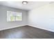 Bright bedroom with wood floors, a large window, and a closet, perfect for rest and relaxation at 2411 Crawford Dr, Sanford, FL 32771