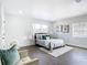 Well-lit bedroom featuring hardwood floors, a cozy armchair, and two windows for natural light at 2411 Crawford Dr, Sanford, FL 32771