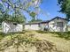 Exterior view showing the main house and a detached shed in a spacious backyard setting at 2411 Crawford Dr, Sanford, FL 32771